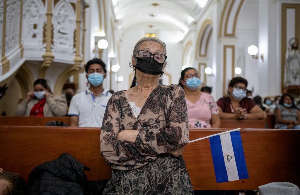 Xiomara Tinoco (59) holds a Nicaraguan flag as she prays at the Matagalpa Cathedral, Managua, Nicaragua, following the arrest of Bishop Rolando Álvarez. Photograph: Inti Ocón/The New York Times