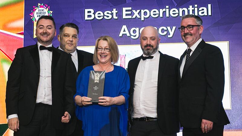 Declan Maxwell, Restaurant Manager, Luna Restaurant presents the Best Experiential Agency award to the Neon Agency team.