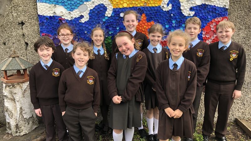 Students of St Clare’s Primary School in Harold’s Cross stand in front of an artwork made from plastic bottle caps. Photograph: Kathleen Harris