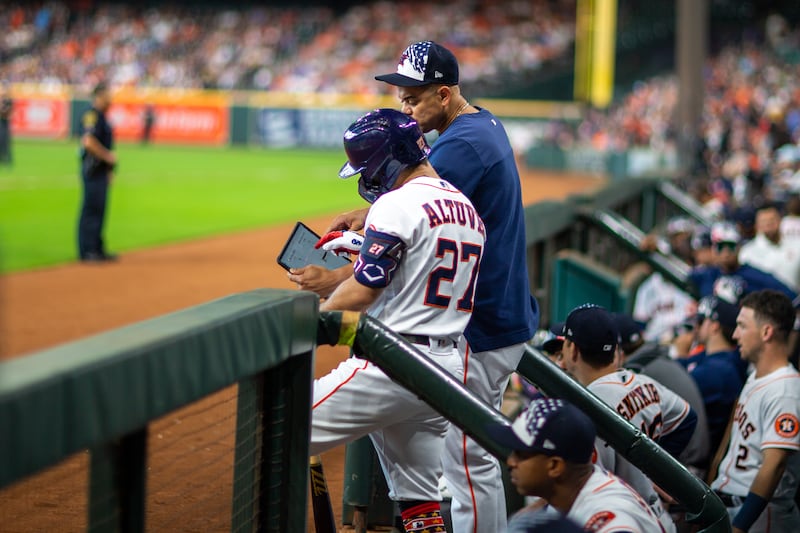 Houston Astros player Jose Altuve hitting coach Alex Cintron consult an iPad in an effort to figure out how to beat the Kansas City Royals. Photograph: Juan DeLeon/Icon Sportswire via Getty Images