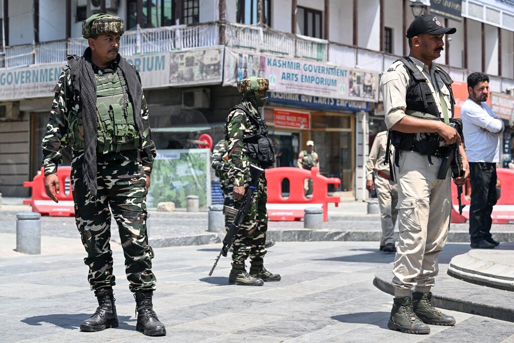 Indian paramilitary troopers stand guard at a market area in Srinagar, Kashmir on Monday (Photo by Tauseef Mustafa / AFP)