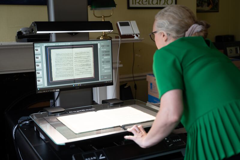 Archivist Maeve Gebruers at work, using a state-of-the-art scanner to digitise and preserve archival materials and music scores Photograph: Conor Mulhern/Eyeon