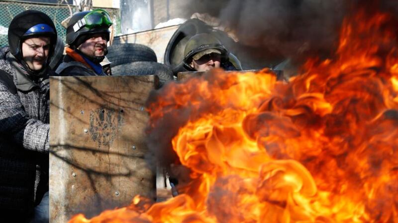 Terror reigns: anti-government protesters guard  barricades near Independence Square in Kiev.  Photograph: Yannis Behrakis/Reuters