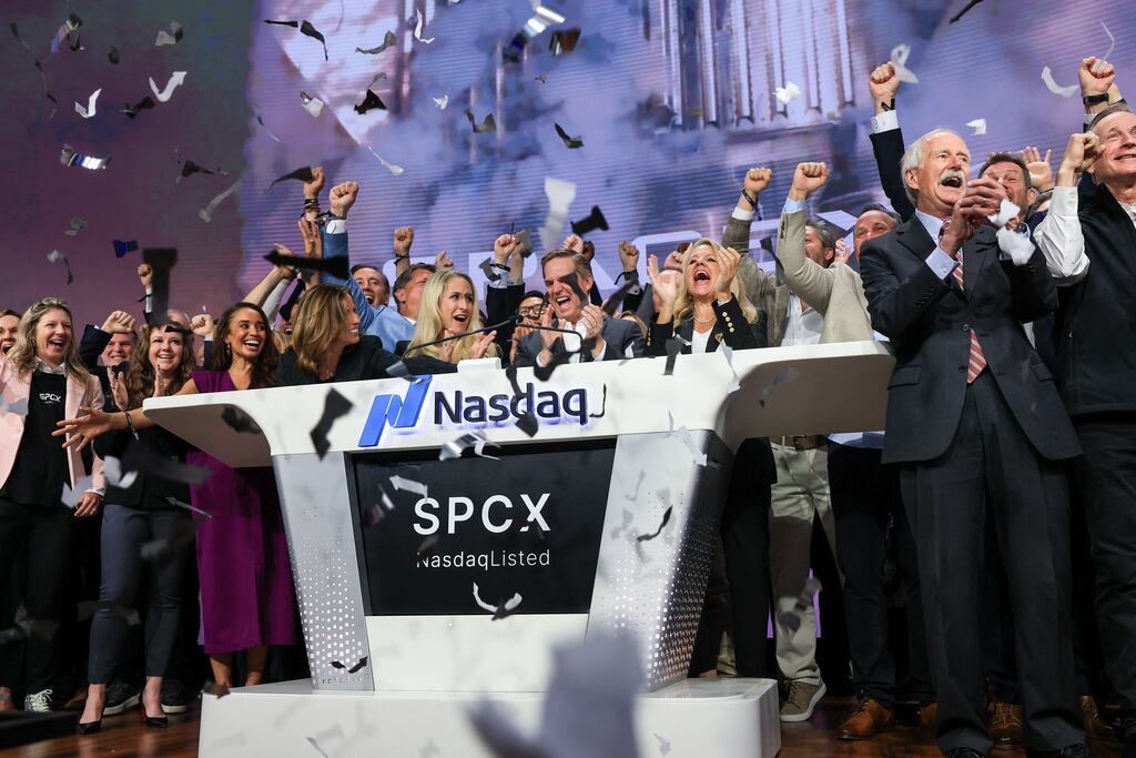 Bret Johnsen (centre), SpaceX chief financial officer, and Gwynne Shotwell (center right), SpaceX oresident and chief operating officer, celebrate with SpaceX employees as they ring the opening bell at the Nasdaq MarketSite to celebrate the launch of SpaceX's initial public offering (IPO) in New York. Photograph: Timothy Clary / AFP via Getty Images