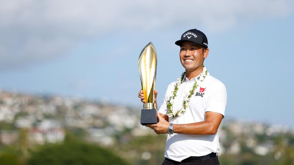 Kevin Na of the United States celebrates with the trophy after winning the Sony Open in Hawaii. Photograph: Getty Images