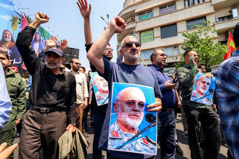 People hold pictures of Major general Gholam Ali Rashid, senior commander of Iran's Islamic Revolutionary Guard Corps (IRGC), as they gather for a protest against Israel's wave of strikes on Iran in central Tehran on June 13, 2025. Photograph: Atta Kenare/ AFP via Getty Images