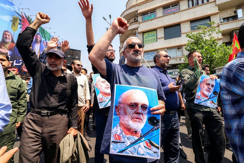 People hold pictures of Major general Gholam Ali Rashid, senior commander of Iran's Islamic Revolutionary Guard Corps (IRGC), as they gather for a protest against Israel's wave of strikes on Iran in central Tehran on June 13, 2025. Photograph: Atta Kenare/ AFP via Getty Images