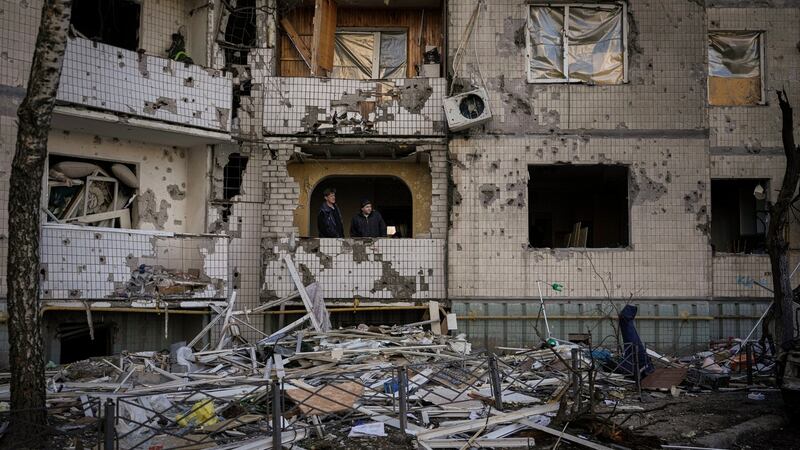 Residents attempt repairs on the shattered windows of an apartment block damaged by a bombing the previous day in Kyiv on Monday.  Photograph: Vadim Ghirda/AP