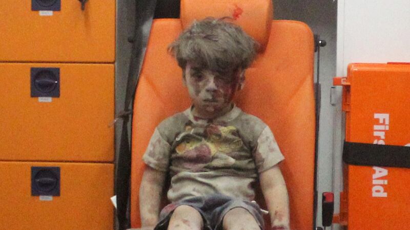 Omran Daqneesh (5) sits inside an ambulance after being rescued following an air strike in the rebel-held al-Qaterji neighbourhood of Aleppo, Syria, in August. Photograph:  Mahmoud Rslan/Reuters
