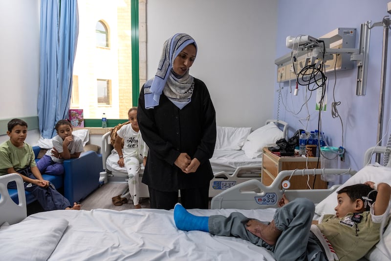 Iyad al-Masri (6) in his hospital room with his mother Shireen and siblings in Abu Dhabi. Photograph: Natalie Naccache/ The New York Times                