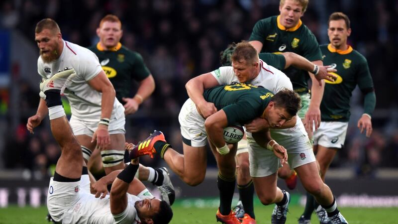 Handre Pollard of South Africa is tackled by Dylan Hartley of England. Photograph:  Shaun Botterill/Getty Images