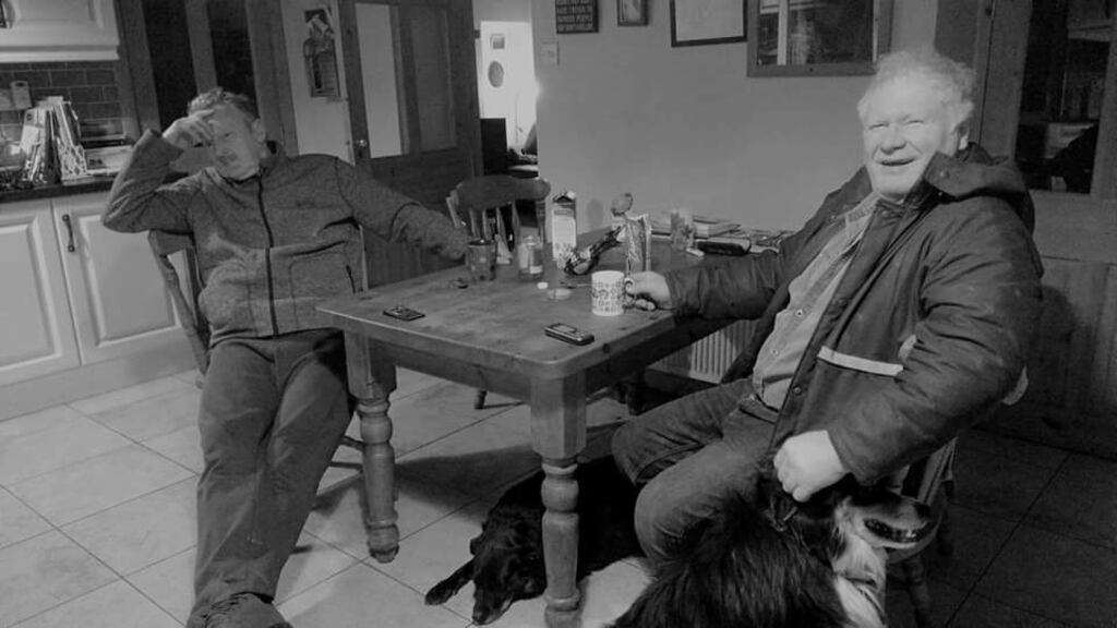 Michael Bob and his friend, Peter Gill, chatting about world affairs in his kitchen in Glen, Clare Island