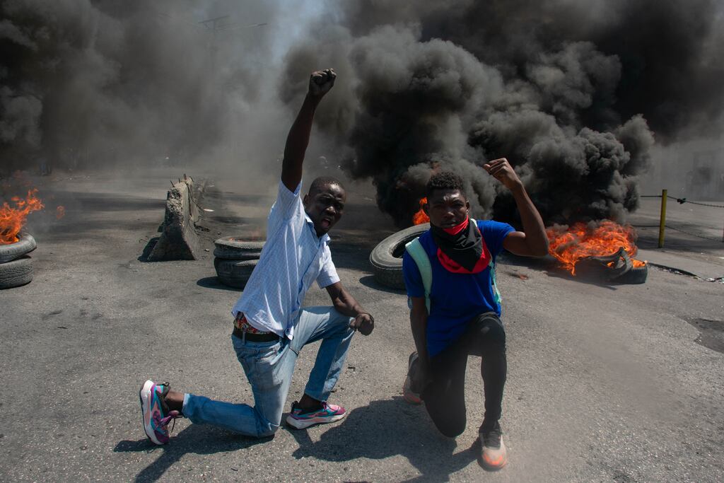 Tyres burn in the street during a demonstration following the resignation of its prime minister Ariel Henry, in Port-au-Prince, Haiti. A political transition deal in Haiti marks a key step forward for the violence-ravaged country, but some experts warn the situation could deteriorate further. (Photo by Clarens Siffroy / AFP)