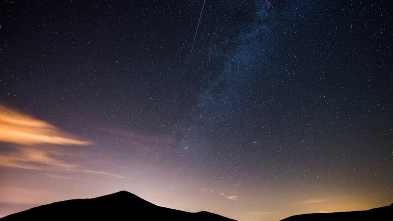 A meteorite of the swarm of meteorites Perseida burns up in the atmosphere next to the Milky Way early 13 August 2017, over San Miguel de Aguayo, Spain. Photograph: Pedro Puente Hoyos/EPA