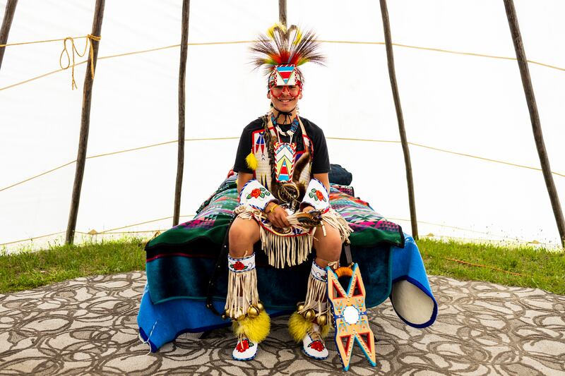 Thomas Addison sits in his family's tepee in his chicken dance outfit. Photograph: Tailyr Irvine/The New York Times