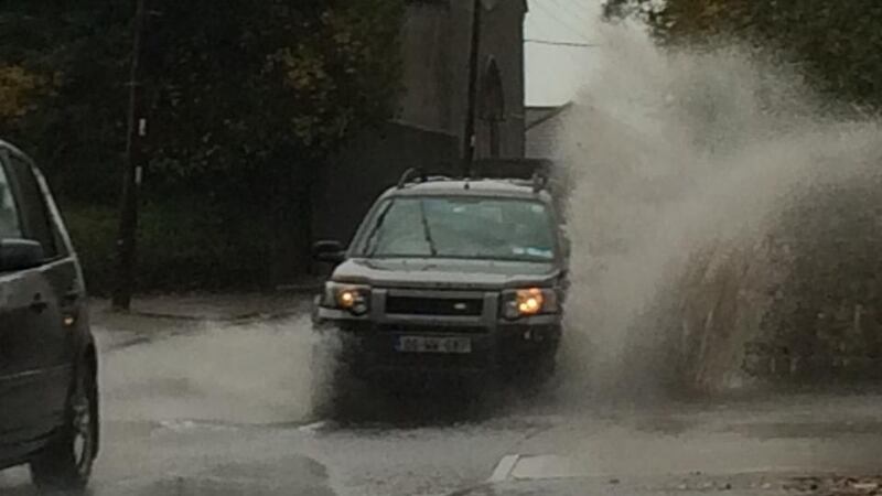 Cars drive through floods in Delgany, Co Wicklow this morning. Photograph: Tim O’Brien
