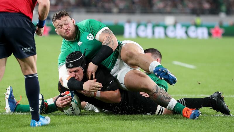 New Zealand’s Matt Todd scores a try despite the efforts of Ireland’s Andrew Porter and Jonathan Sexton. Photograph: Billy Stickland/Inpho