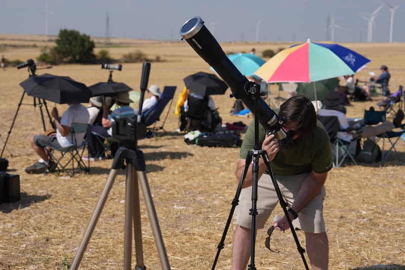 Astronomy enthusiasts make their final adjustments to telescopes ahead of solar eclipse observation in Lodoso, Burgos province, Spain. Photo by Cesar Manso/AFP via Getty Images