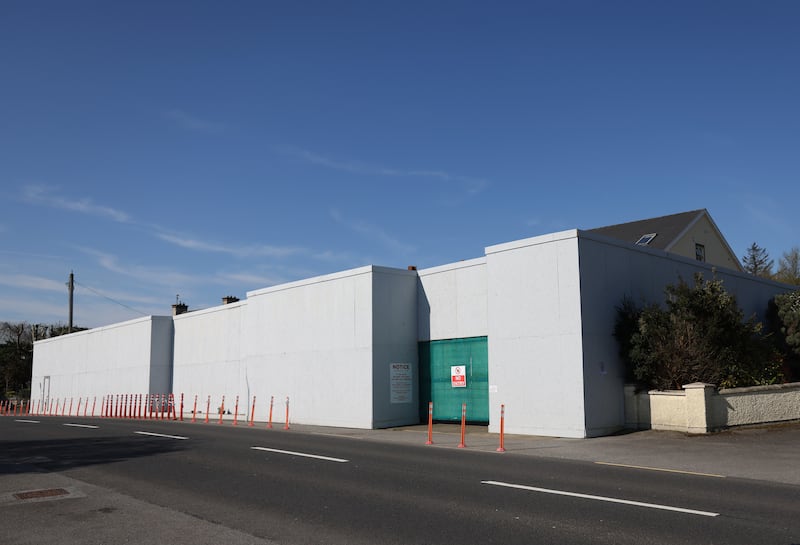 A large wooden wall seals off the site of the explosion. Photograph: Bryan O’Brien/The Irish Times
