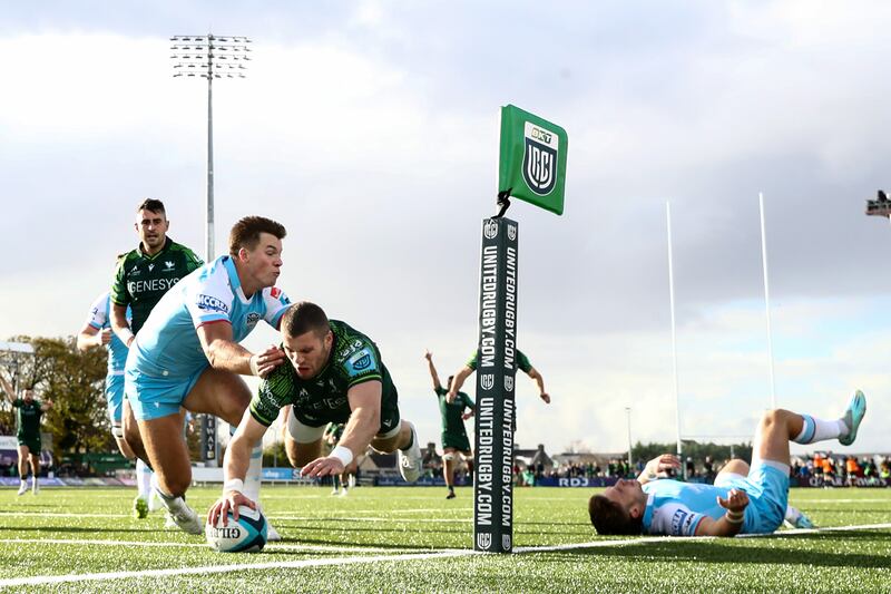 Connacht's Diarmuid Kilgallen dives to score the opening try despite the efforts of Huw Jones of Glasgow Warriors. Photograph: Ben Brady/Inpho
