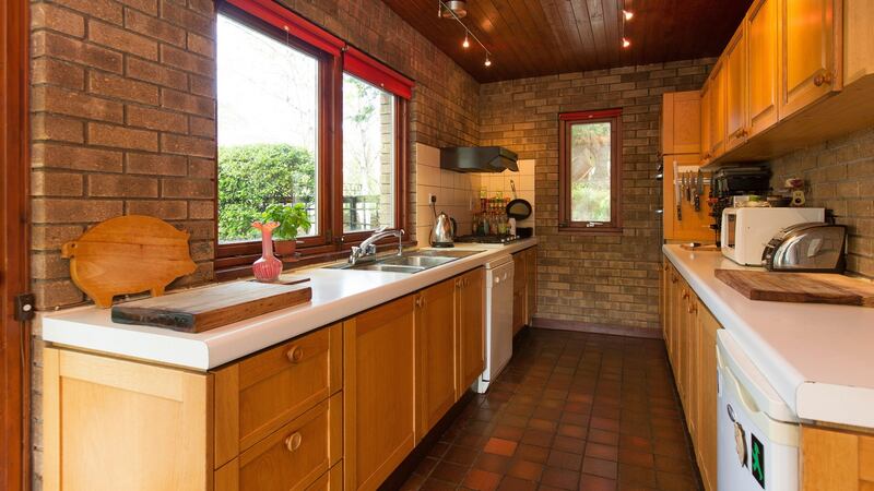 The livingroom opens  directly into the galley-style kitchen at the front of the house