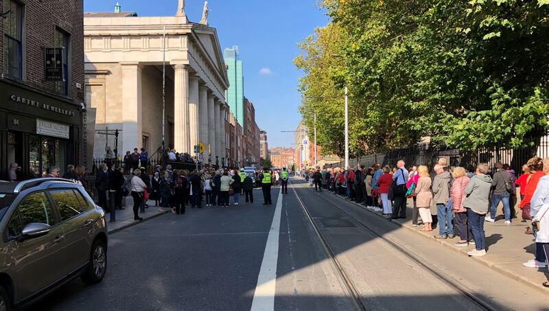 Crowds gather to pay their respects to the late Emma Mhic Mhathúna outside the Pro-Cathedral in Dublin on Wednesday. Photograph: Daniel Comer