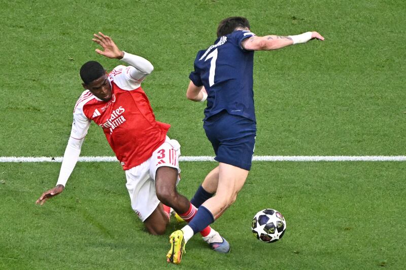 Arsenal's Cristhian Mosquera tackles Paris Saint-Germain's Khvicha Kvaratskhelia inside the box during the UEFA Champions League final. Photograph: Attila Kisbenedek/AFP via Getty Images