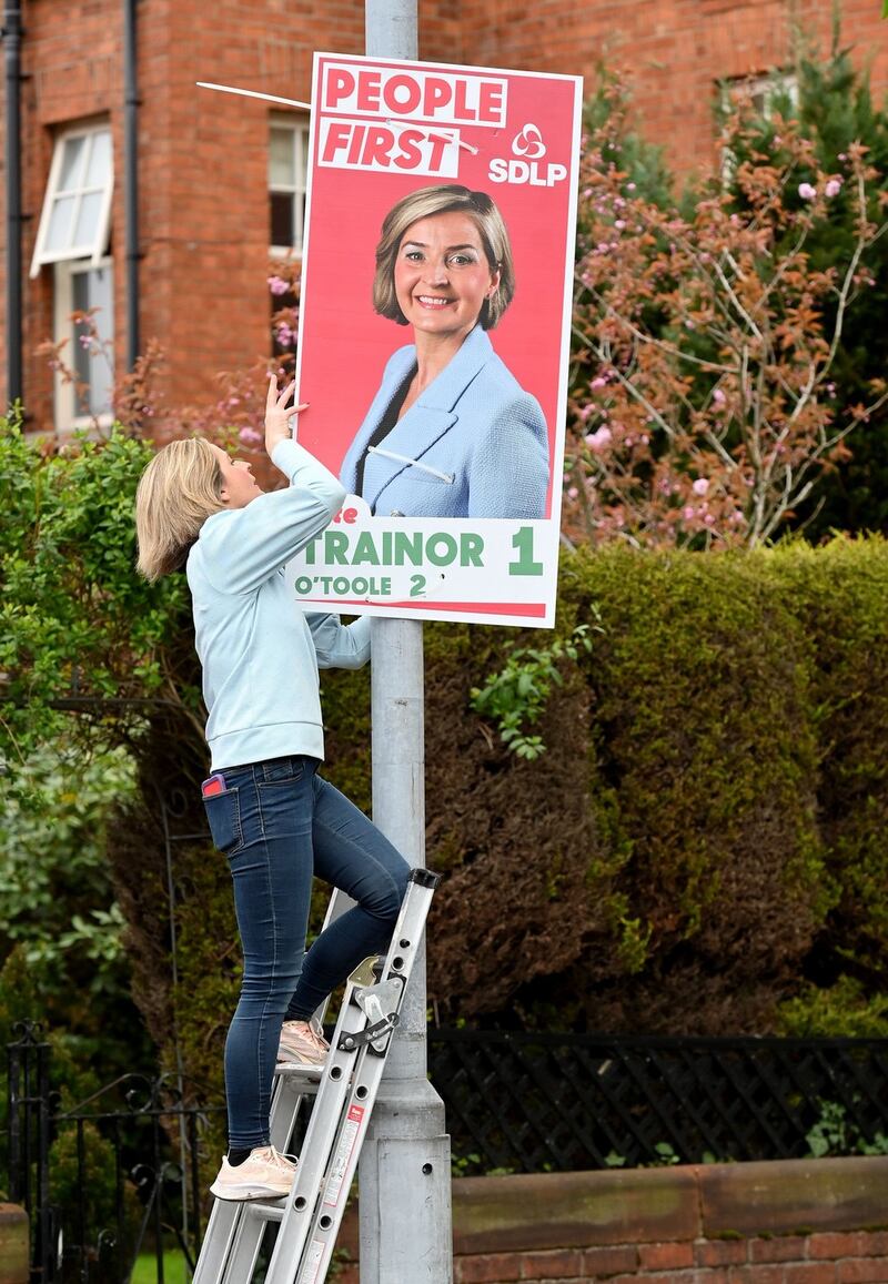 SDLP candidate Elsie Trainor     puts up her electoral posters on the Ravenhill Road in Belfast. Photograph: Stephen Hamilton/Presseye