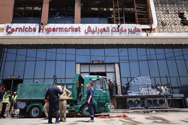 A cleaning operation starts after a fire tore through a newly opened shopping centre overnight in the eastern Iraqi city of Kut. Photograph: AHMAD AL-RUBAYE/AFP via Getty Images 