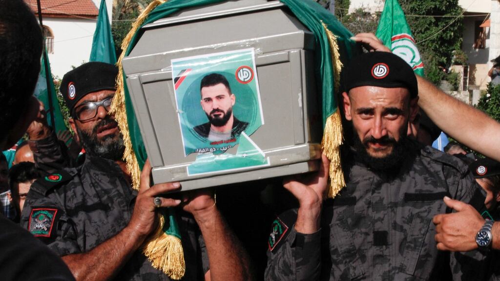 Members of the Amal movement carry the flag-draped casket of a fellow fighter who was killed in clashes in Beirut. Photograph: Mahmoud Zayyat/AFP via Getty