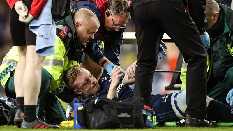Dan Leavy receives treatment on the pitch after suffering a knee injury in Leinster’s Heineken Champions Cup quarter-final against Ulster at the Aviva Stadium in March 2019. Photograph:  Billy Stickland/Inpho