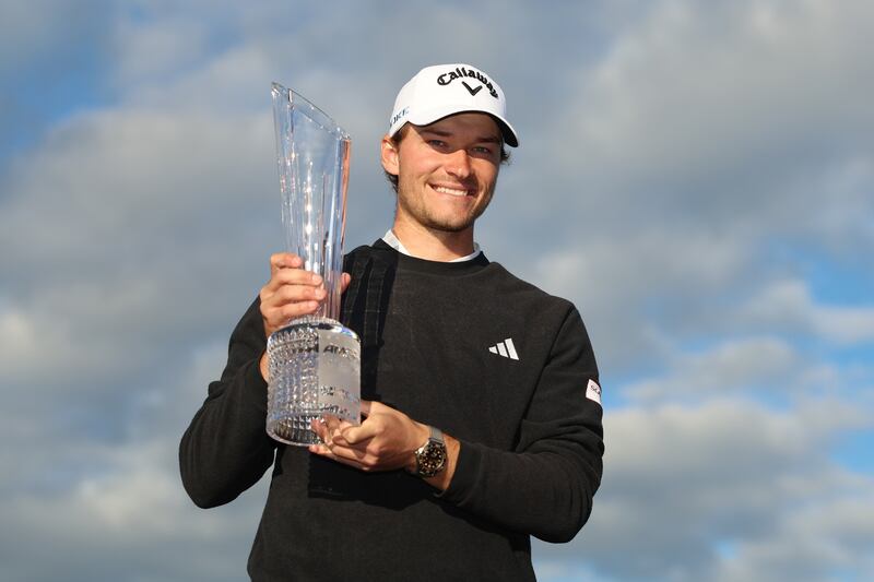 Denmark's Rasmus Hojgaard celebrates with the trophy on the 18th green after winning the 2024 Irish Open. Photograph: Luke Walker/Getty Images