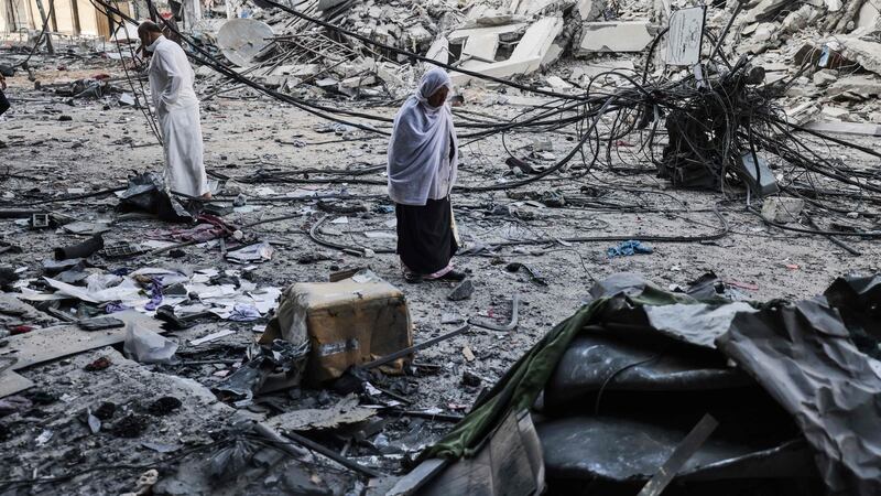 Palestinians after performing Eid al-Fitr prayers amid debris near the al-Sharouk tower in the Gaza Strip  after it was destroyed by an Israeli air strike. Photograph:   Mohammed Abed/AFP via Getty Images
