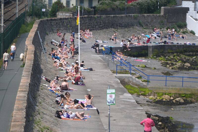 Sunbathers at Seapoint in Dun Laoghaire Co Dublin. Photograph: Niall Carson/PA Wire
