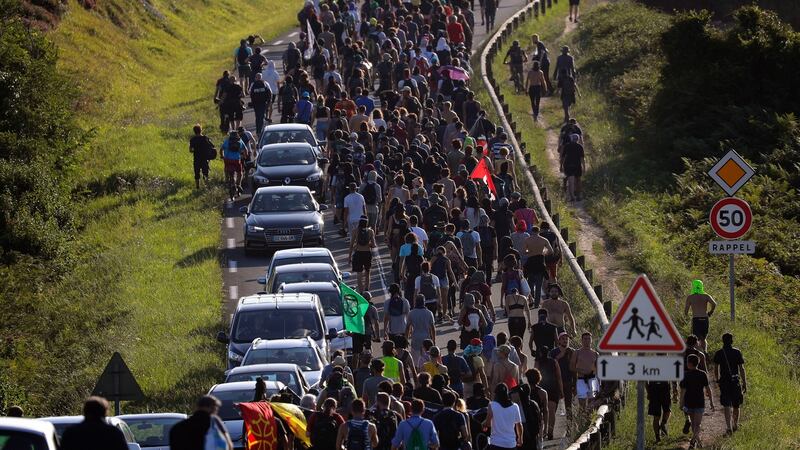Anti-G-7 activists march along a road near a tent camp near Hendaye, France on Friday. Photograph: Emilio Morenatti/AP