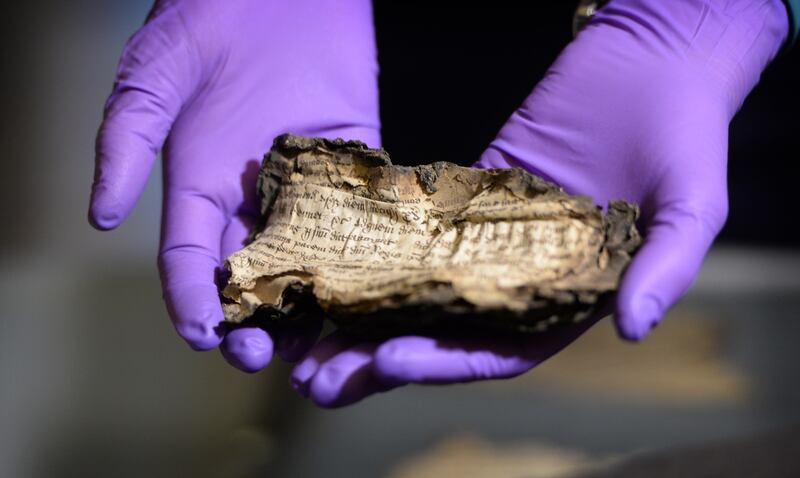 Zoe Reid, senior conservator with the National Archive of Ireland, holds a Henry Vlll Plea roll, at the launch of Beyond 2022: Ireland's Virtual Record Treasury research project in Decemeber 2019. Photograph: Dara Mac Dónaill/The Irish Times




Photograph: Dara Mac Donaill / The Irish Times