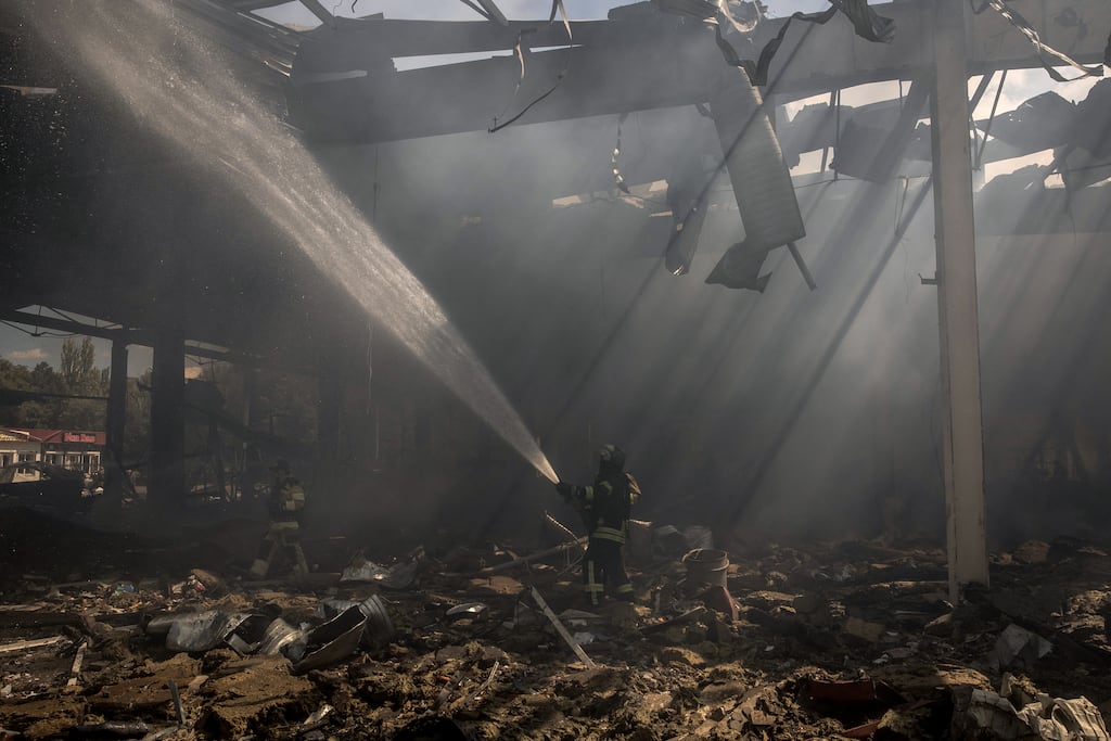 Ukrainian emergency and rescue personnel operate at the site of the destroyed supermarket following a Russian strike in Kostyantynivka, eastern Donetsk region. Photograph: Roman Pilipey/AFP via Getty Images