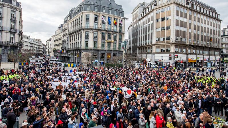People gather in front of Brussels Stock Exchange to commemorate the victims of last year’s terrorist attacks  in the city. Photograph: Stephanie LeCocq/EPA