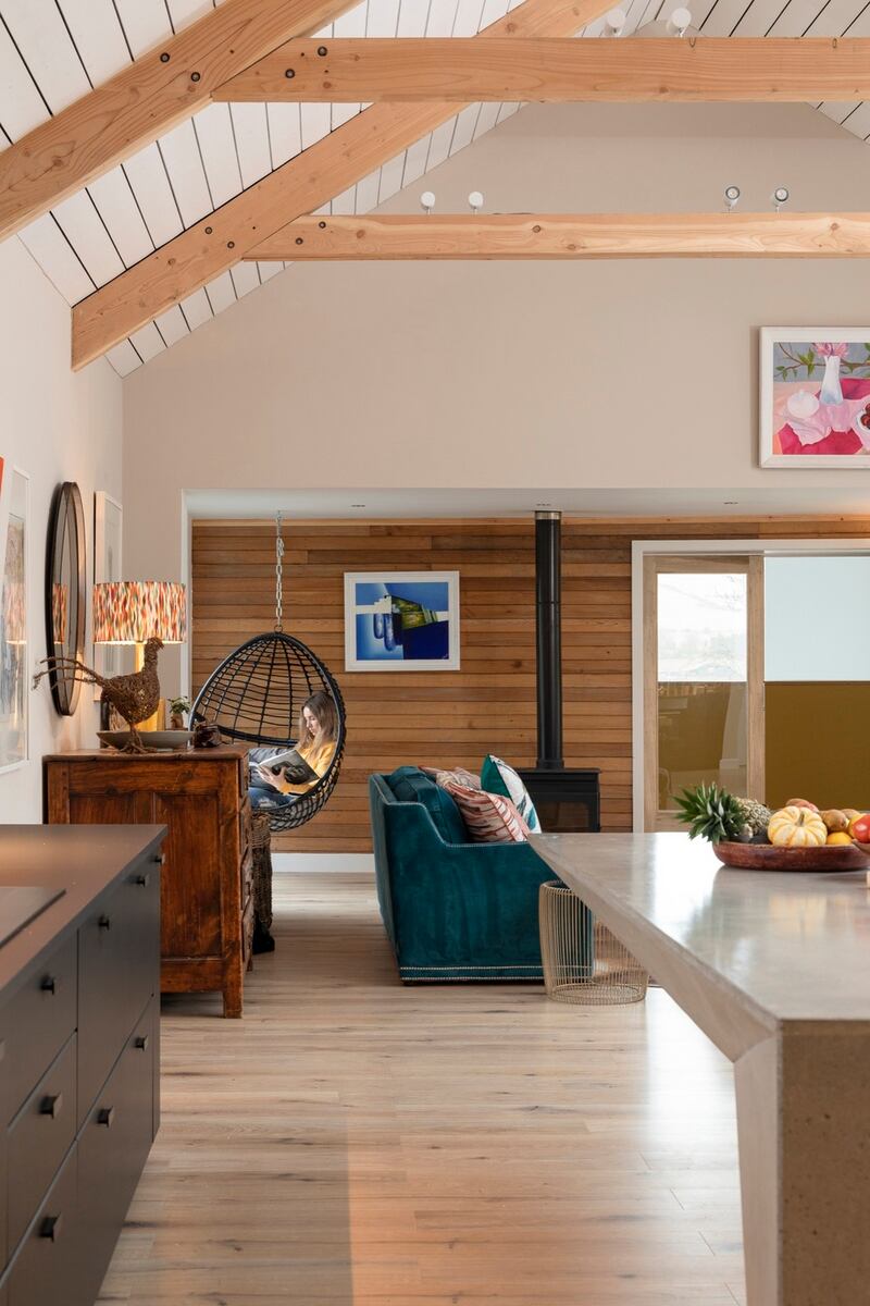 The wall’s cedar slats originally featured on the exterior of the house have been repurposed inside. Photograph: Brian McLochlainn