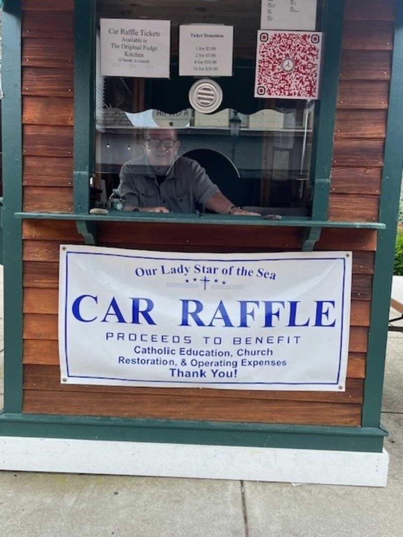 Joe Fahy volunteering as a ticket salesman in the booth in front of the Star of the Sea church 