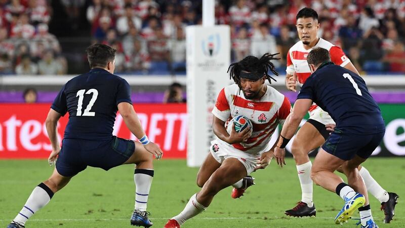 Japan hooker Shota Horie runs at Scotland’s  Sam Johnson  and  Allan Dell during the  Rugby World Cup Pool A match  at the International Stadium in Yokohama. Photograph: William West/AFP via Getty Images