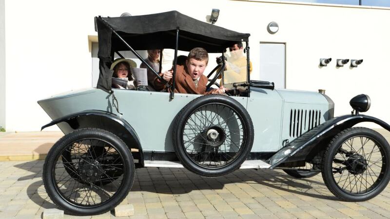 James Archbold from Tallaght with Ronan and Neala O Morain from Dalkey in one of the Overend vintage cars at Airfield