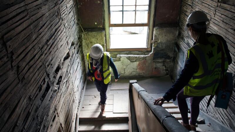 Carl Raftery, a  conservation research officer with Dublin City Council,   with reporter Olivia Kelly in the 17th century house on Aungier Street, Dublin, that is being  restored. Photograph: Brenda Fitzsimons
