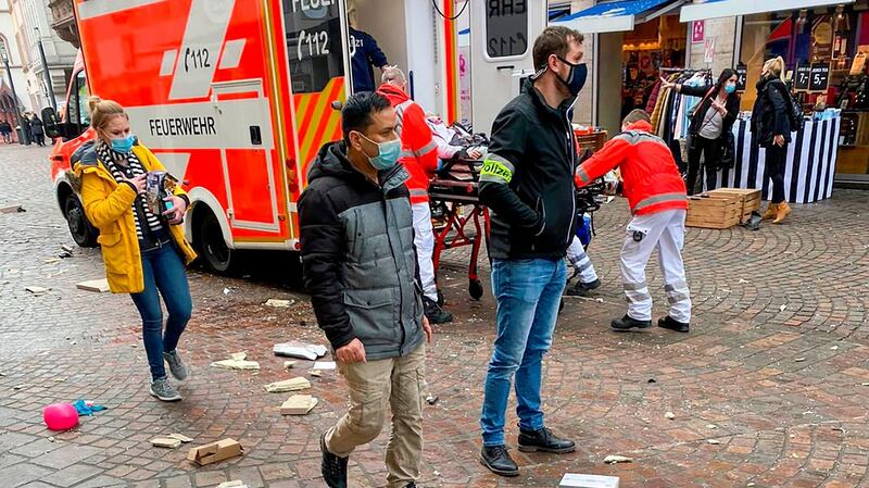 Police look on as rescuers push an injured person into an ambulance at the scene in Trier, southwestern Germany. Photograph: Sebastian Schmitz/AFP via Getty Images