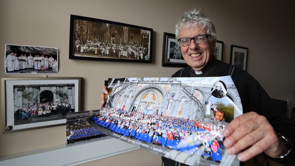 Fr Martin Noone, director of Dublin Diocesan Pilgrimages, with a group photograph from one of their many trips. Photograph: Nick Bradshaw