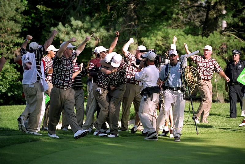 Justin Leonard is mobbed by the American team after sinking a long birdie putt on the 17th during the final day of the 1999 Ryder Cup at Brookline Country Club in Boston. Photograph: Stephen Munday/Allsport