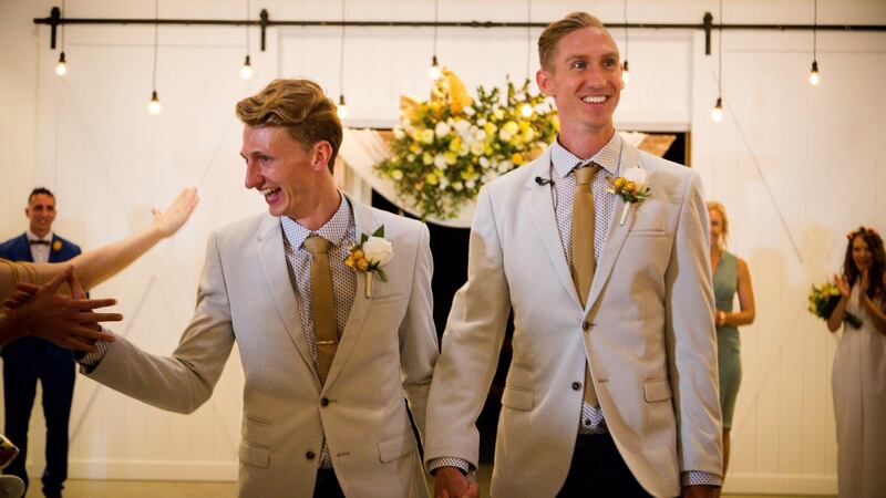 Australian Commonwealth Games sprinter Craig Burns (R) and fiancé Luke Sullivan (L) are congratulated by friends after exchanging vows at their marriage ceremony at Summergrove Estate, New South Wales. Photograph: Patrick Hamilton/EPA
