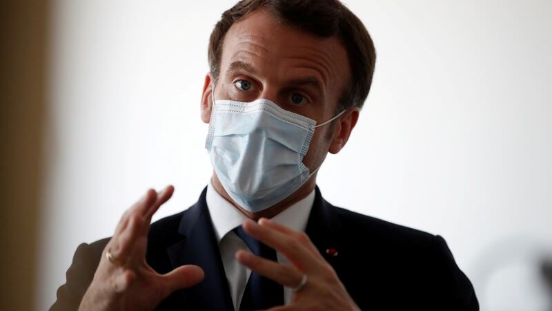 Emmanuel Macron speaking with health workers at a medical centre near Paris. Photograph: Gonzalo Fuentes/Reuters