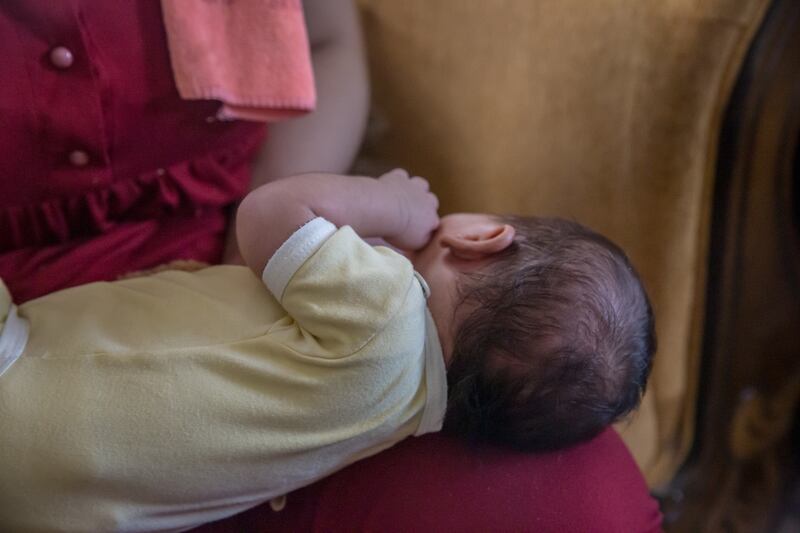 Sabah Abu Srour's baby lies on her lap as she recounts her experiences with settlers. Photograph: Sally Hayden