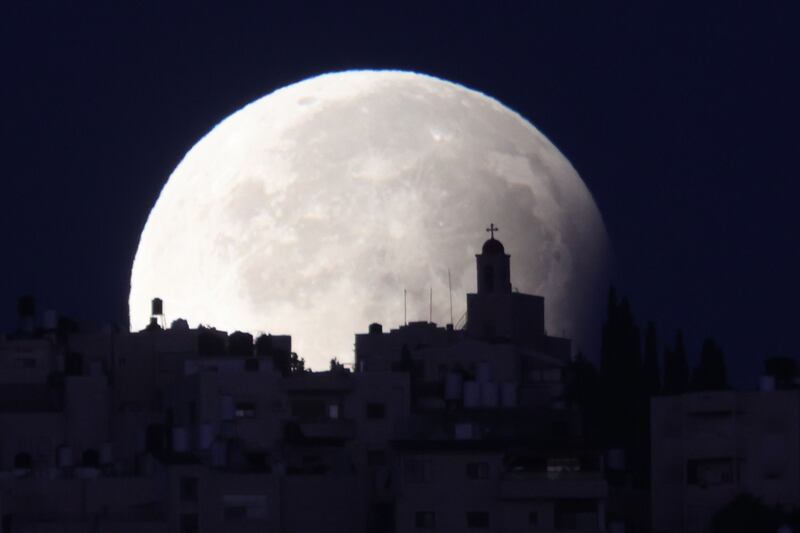 Israel: A supermoon with a partial lunar eclipse sets over the old city of Jerusalem. Photograph: Abir Sultan/EPA-EFE